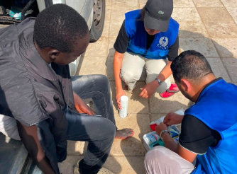 Aid workers assists an injured migrants on the Spain–Morocco border in Ceuta